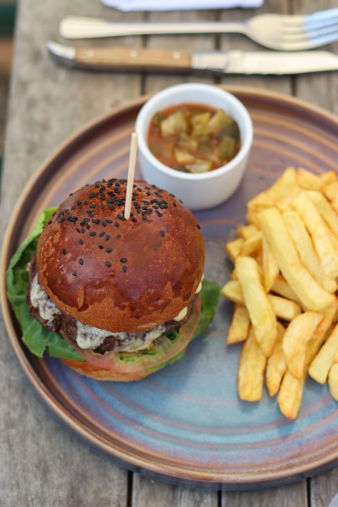 Close up shot of The Bull Burger served with chips.